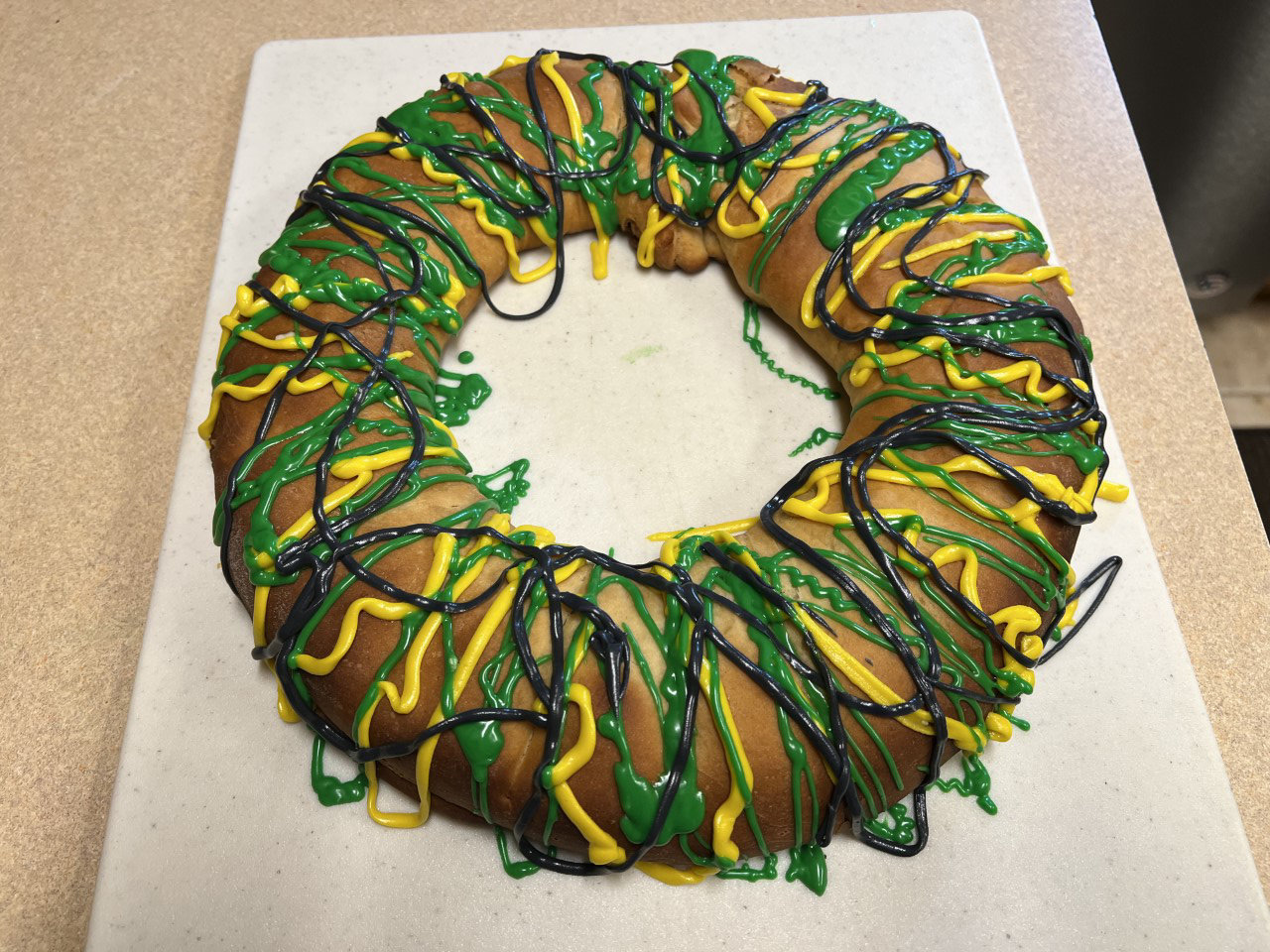 King Cakes are decorated with purple, gold (or yellow) and green icing